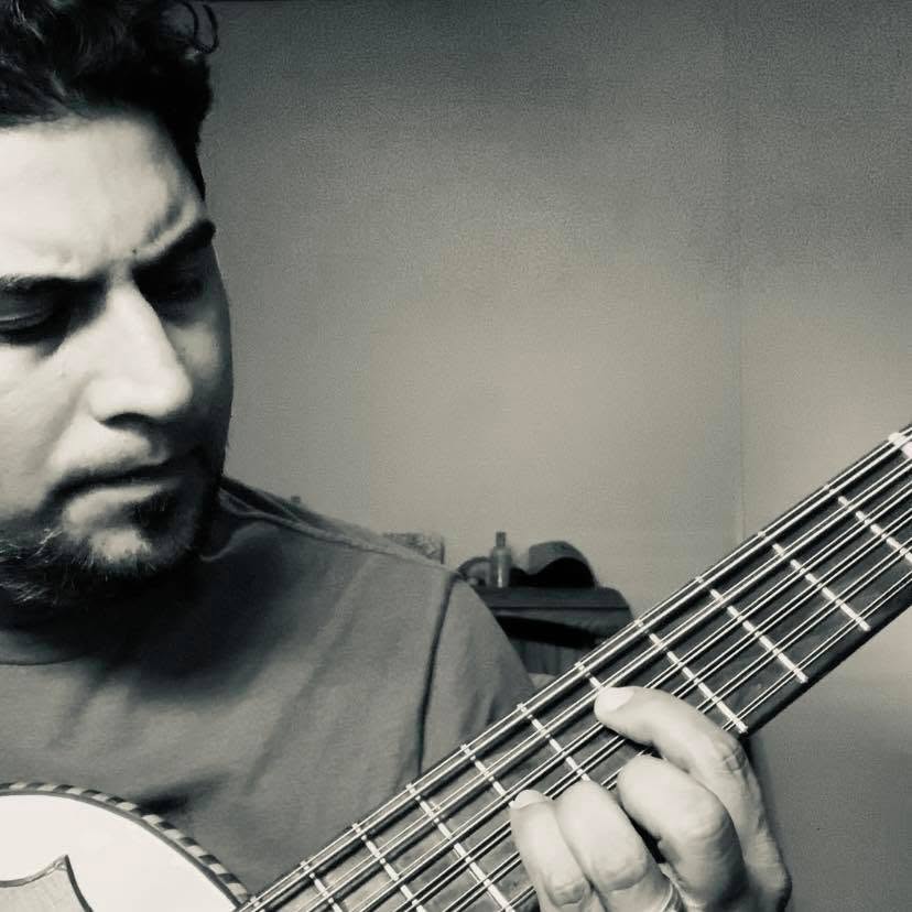 Augustine Moya playing guitar live on stage