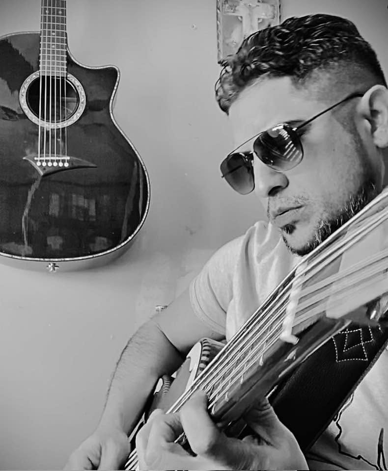 Portrait of Augustine Moya with guitar